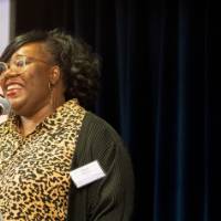 Woman speaking at a microphone